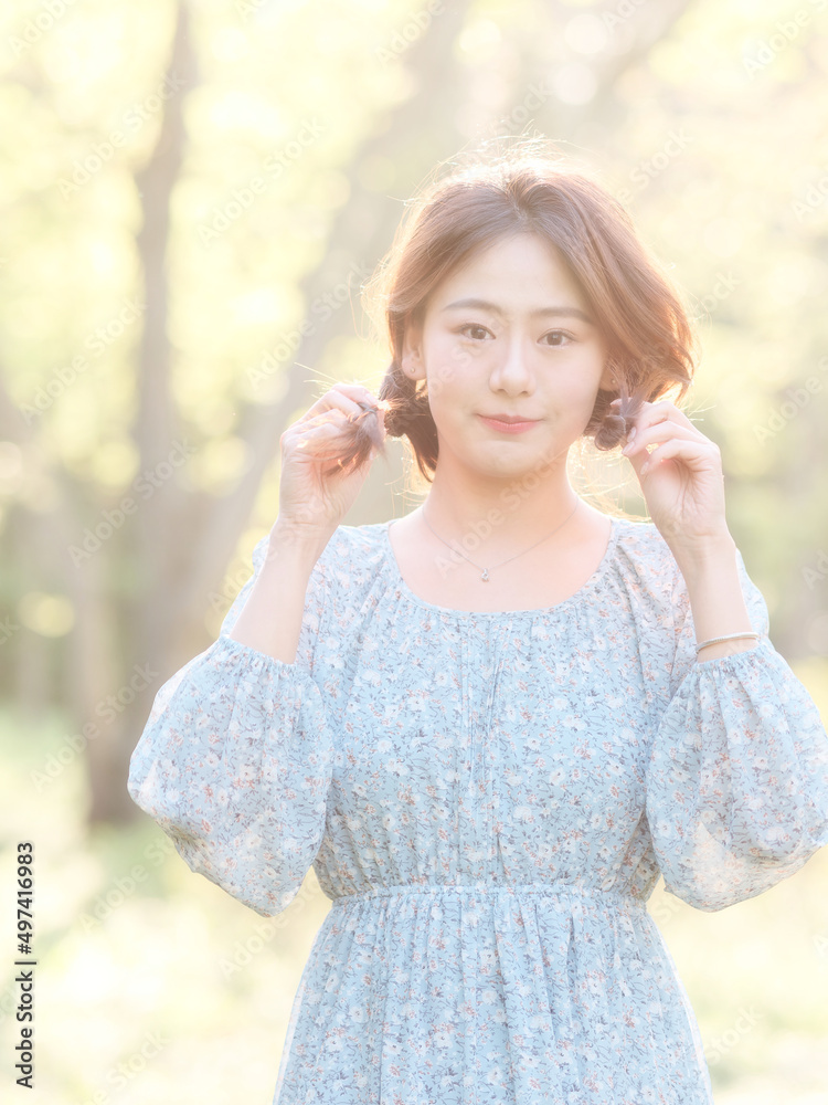 Portrait of elegant Chinese girl in dress enjoy carefree time in forest park in sunny day. Outdoor fashion portrait of glamour young Chinese cheerful stylish woman. Portrait of elegant Chinese girl in dress enjoy carefree time in forest park in sunny day. Outdoor fashion portrait of glamour young Chinese cheerful stylish woman.