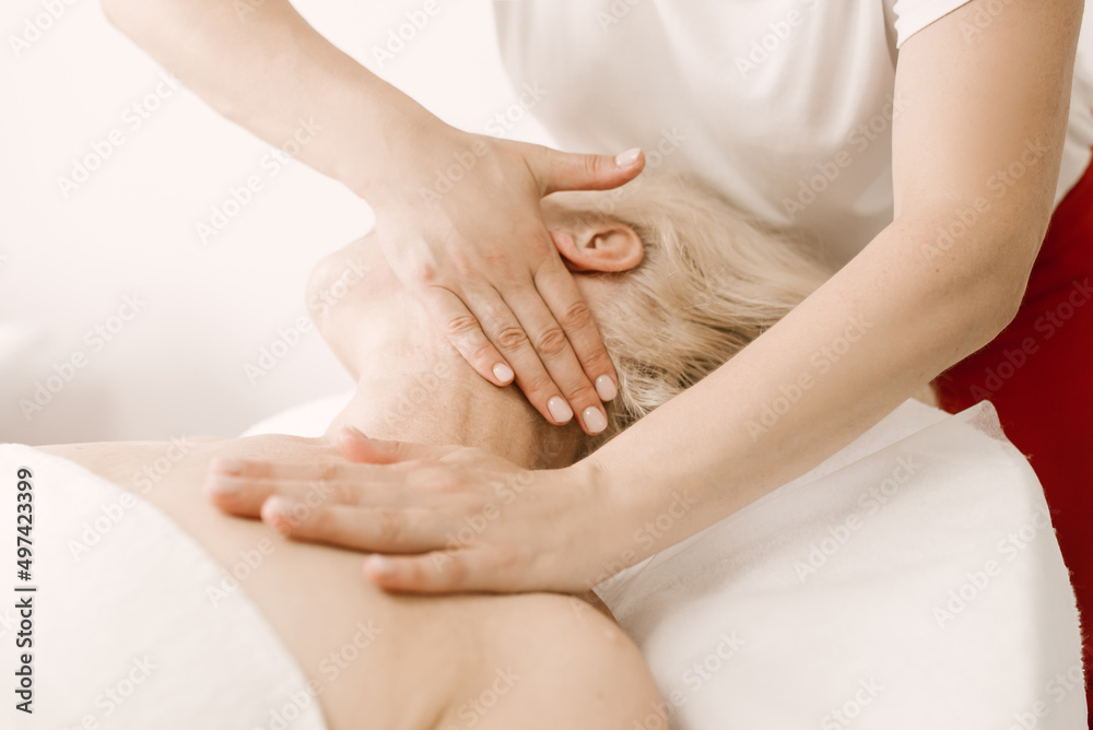 Massage and body care. a mature woman receives a relaxing and toning facial and neck massage at the spa. Massage and body care. a mature woman receives a relaxing and toning facial and neck massage at the spa.