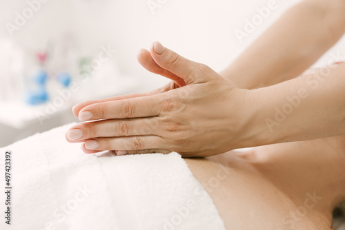 Massage and body care. a woman in adulthood receives a relaxing and toning massage of the face and neck, chest in the spa.