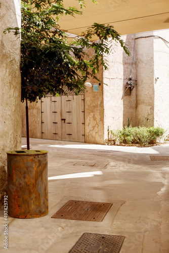 An old narrow street and the entrance doors of a house in the traditional Arabic style in old Dubai © Sviatlana