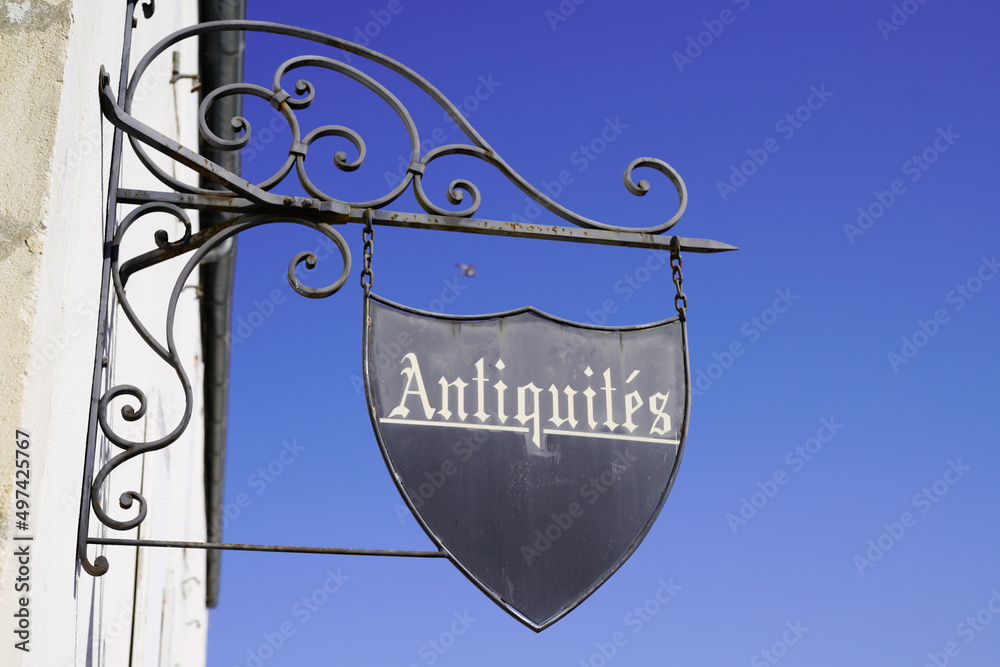 store facade wall panel in the street with retro text antiques in