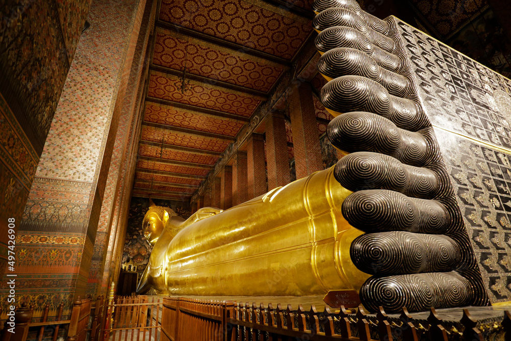 The giant reclining Buddha golden statue is seen in Wat Pho temple ...