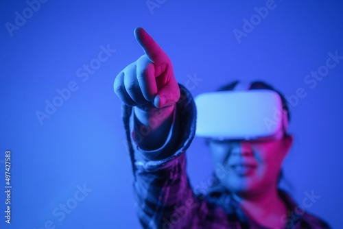 Girl wearing virtual reality goggles, Future technology concept, finger touching the screen