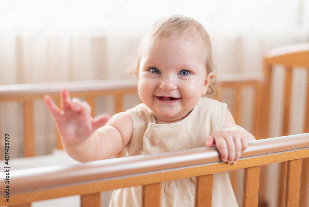 Portrait of a happy and laughing baby in a crib Portrait of a happy and laughing baby in a crib