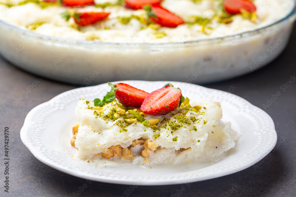 Close-up walnut gullac dessert. Traditional Ramadan dessert. Middle Eastern desserts. Close-up walnut gullac dessert. Traditional Ramadan dessert. Middle Eastern desserts.