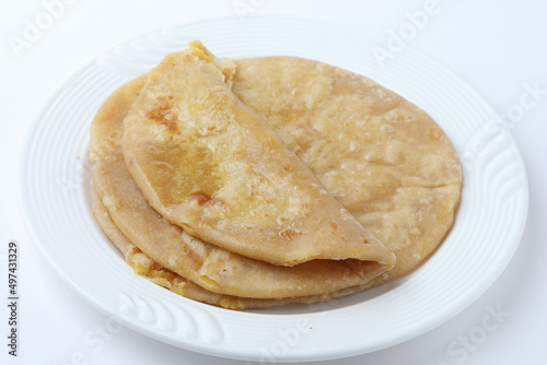Traditional Indian food Aloo paratha or potato stuffed flat bread. served with curd