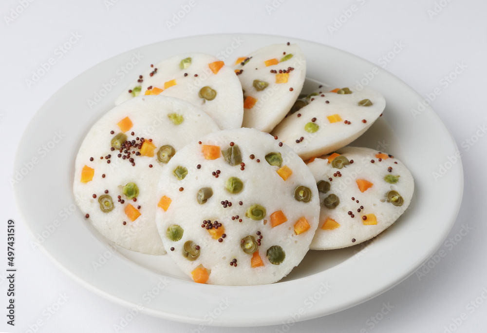 vegetable idli served with coriander and coconut chutney with tomato sauce vegetable idli served with coriander and coconut chutney with tomato sauce