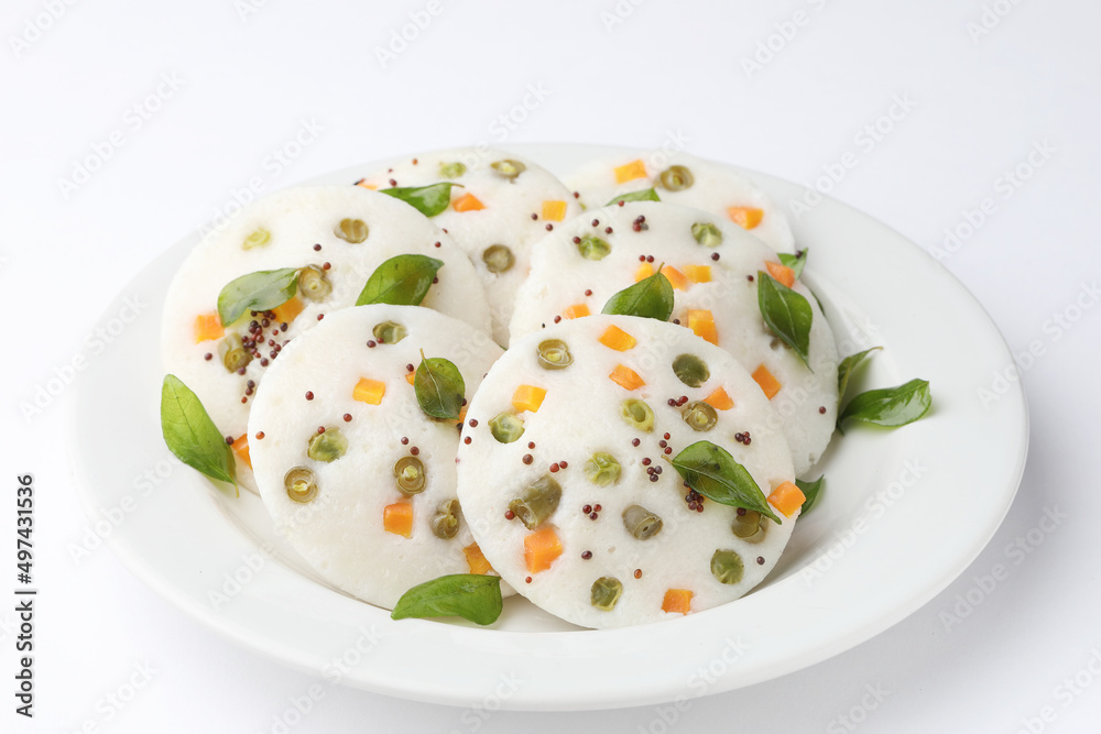 vegetable idli served with coriander and coconut chutney with tomato sauce vegetable idli served with coriander and coconut chutney with tomato sauce