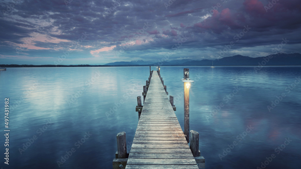 wooden pier on lake, romantic evening 