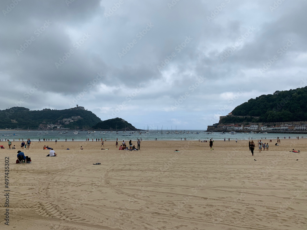 People enjoying summer day at San Sebastian beach La Concha in Basque Country