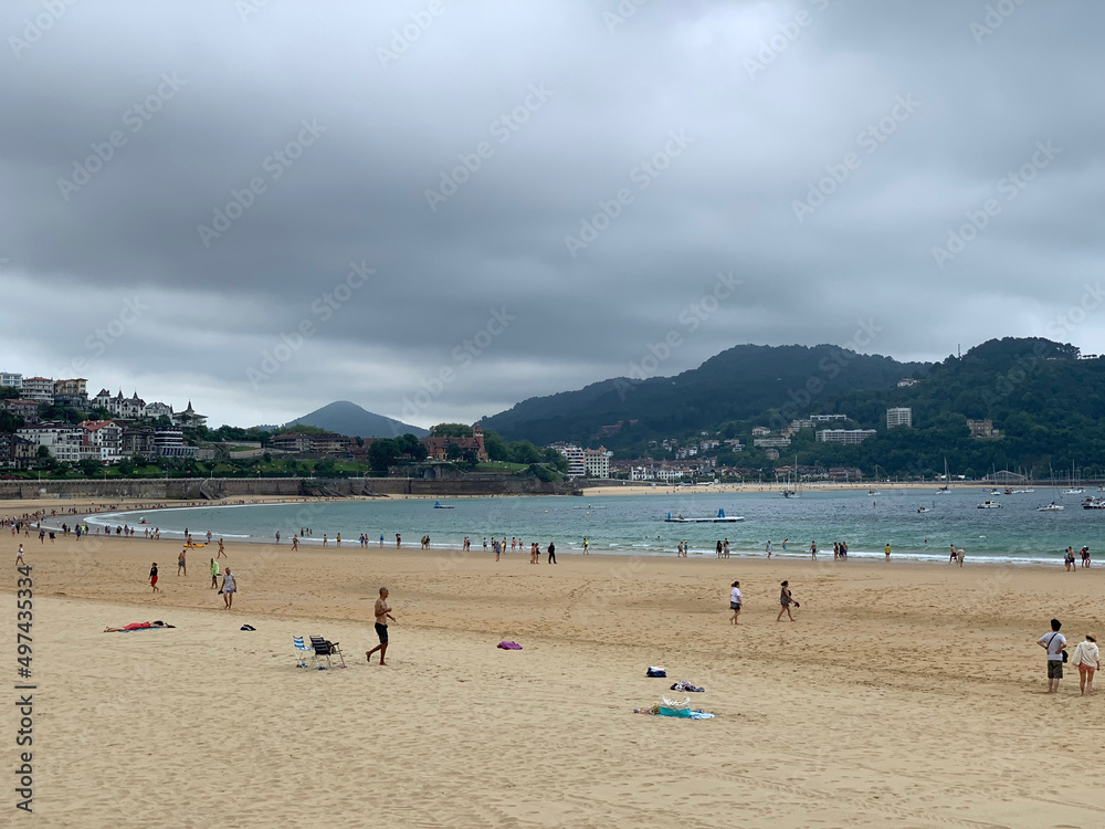 People enjoying summer day at San Sebastian beach La Concha in Basque Country