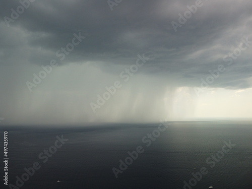 Bild auf Leinwand Aerial view footage of rain clouds over sea ocean Black clouds in bad weather day over sea surface High angle view nature view