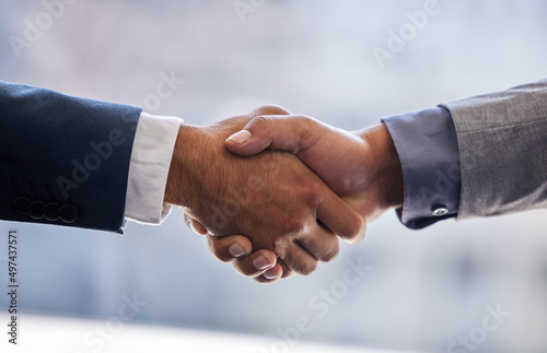 Ready to leave our mark in the business world. Cropped shot of two unrecognizable businesspeople standing together and shaking hands in the office.