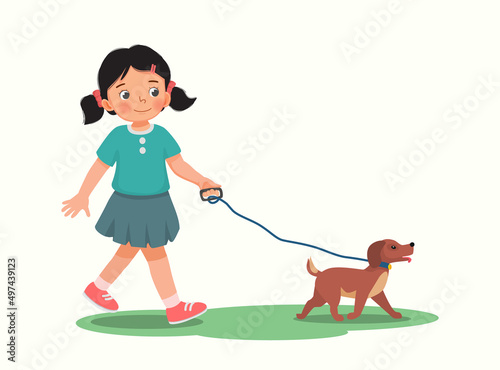 Cute little girl walking the dog in the park 