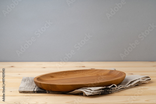 Cutting board with cotton napkin on wooden table