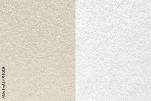 Texture of craft beige and white paper background, half two colors, macro. Structure of cream craft cardboard.