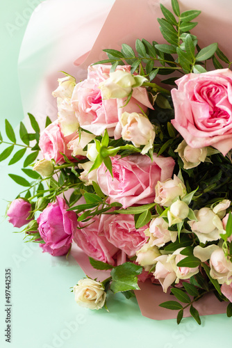 Mother s day  womens day or birthday card. Beautiful bouquet of blooming delicate pink roses on a green background.