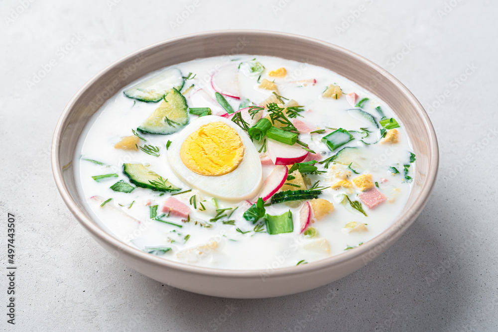 Cold, summer okroshka soup with vegetables, egg, fresh herbs and kefir. Side view, close-up. Cold, summer okroshka soup with vegetables, egg, fresh herbs and kefir. Side view, close-up.