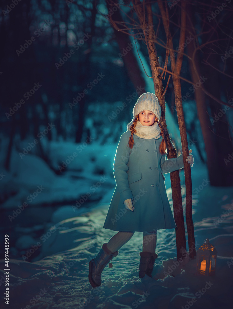 Girl walking in the night winter park