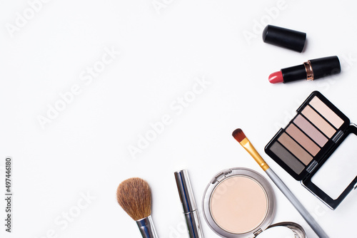 Powder, eye shadow, mascara, brushes are on a white background. Cosmetics for women on a white background and a place for text