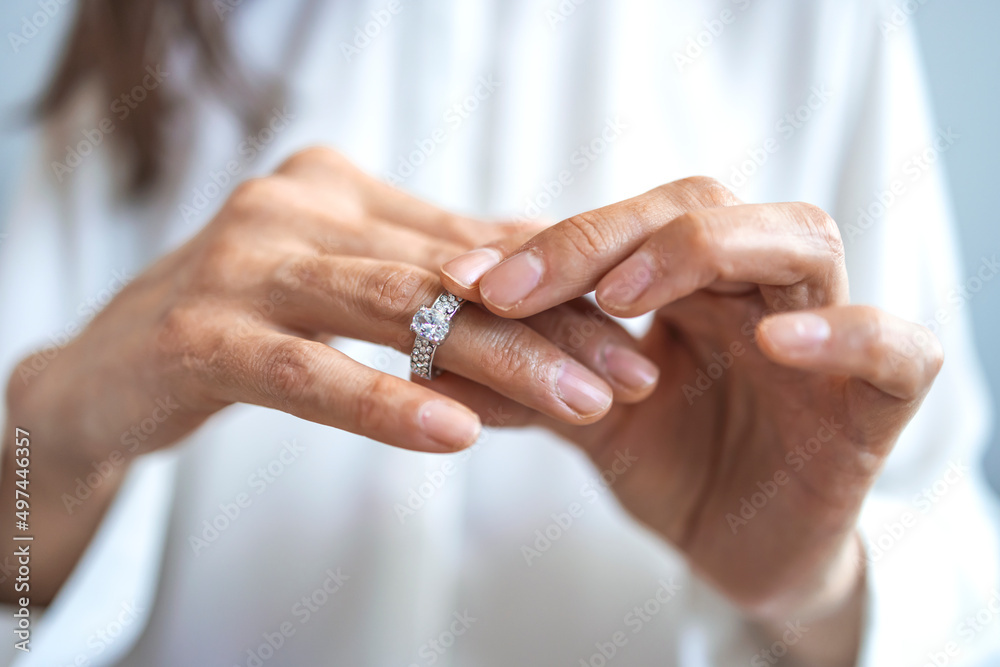 Unhappy woman holding wedding ring close up, upset girl crying, depressed with divorce, break up with boyfriend, broken engagement, feeling desperate, family split, bad relationships