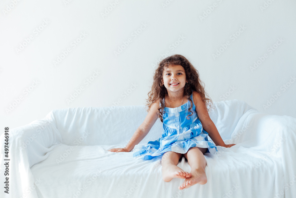 beautiful curly little girl in a blue dress beautiful curly little girl in a blue dress