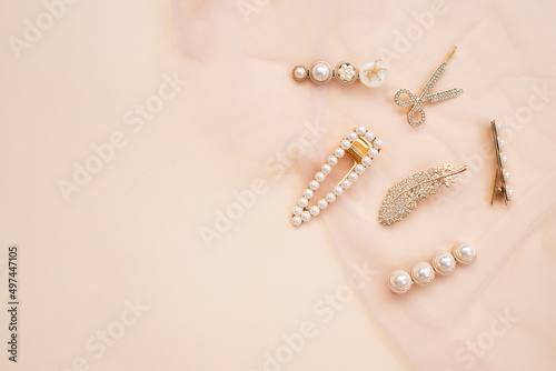 pattern of hair clips with pearls on beige background photo