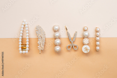 pattern of hair clips with pearls on color background photo