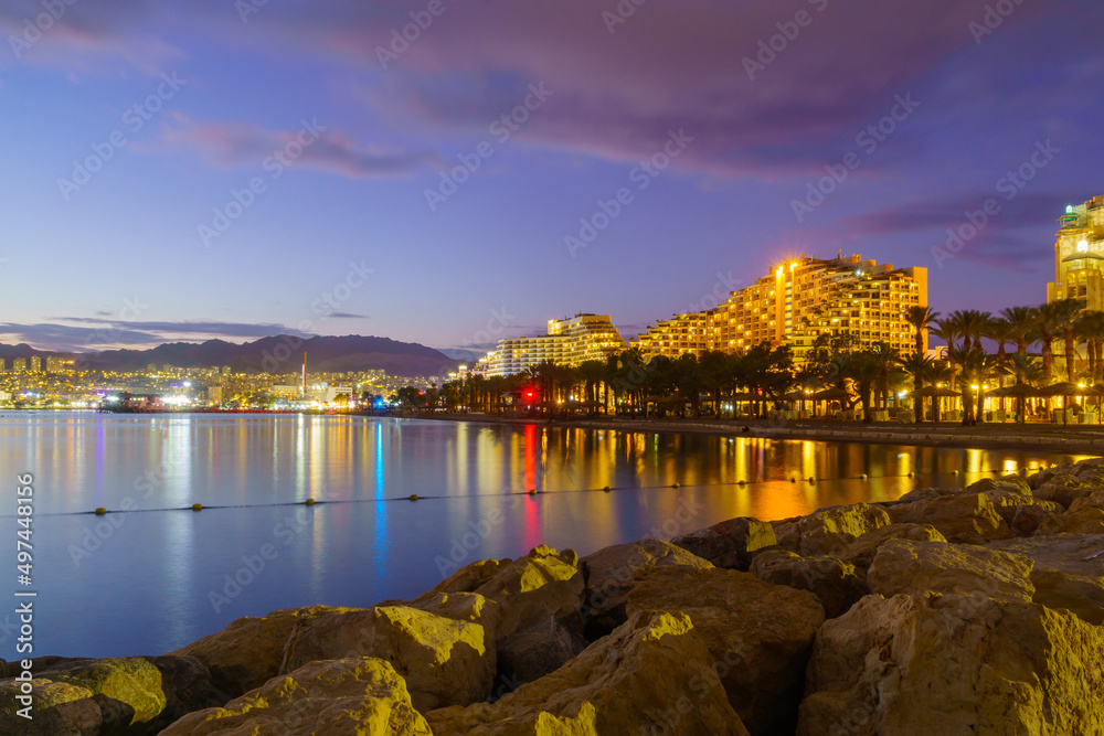 Evening view of the promenade, with hotel buildings. Eilat
