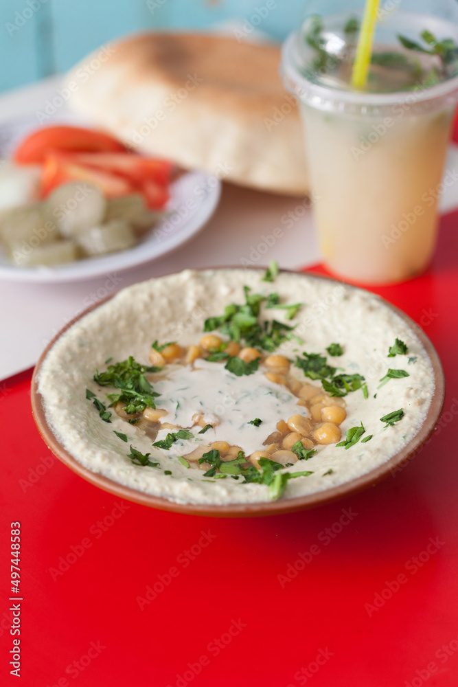 Hummus served with pita bread, vegetables and a cold beverage Hummus served with pita bread, vegetables and a cold beverage
