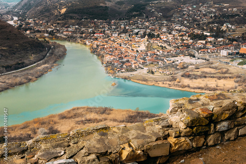 Fototapeta Naklejka Na Ścianę i Meble -  Mtskheta, Georgia. Top View Of Ancient Town Located At Valley Of Confluence Of Rivers Mtkvari Kura And Aragvi In Picturesque Highlands. Early Spring Autumn Season. Svetitskhoveli Cathedral Of The