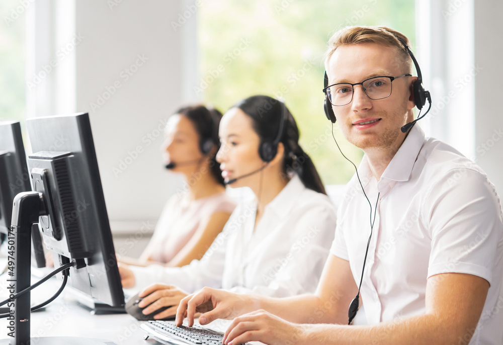 Team of professional support staff working in the office. Colleagues in the workplace solve customer problems. Call center and customer support concept. Team of professional support staff working in the office. Colleagues in the workplace solve customer problems. Call center and customer support concept.
