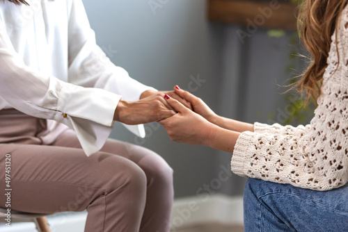 Psychologist hold hands of girl patient, close up. Teenage overcome break up, unrequited love. Abortion decision. Psychological therapy, survive personal crisis, individual counselling concept