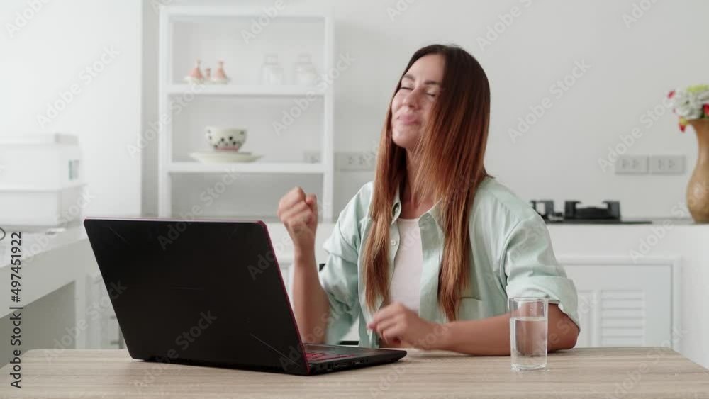 Funny euphoric young woman customer celebrating winning bid or getting ecommerce shopping offer on laptop. Excited girl winner looking at screen monitor celebrating success concept. Funny euphoric young woman customer celebrating winning bid or getting ecommerce shopping offer on laptop. Excited girl winner looking at screen monitor celebrating success concept.