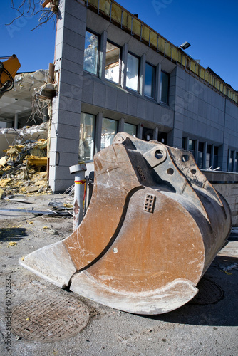 excavator scoop at a demolition site © EsaHiltula