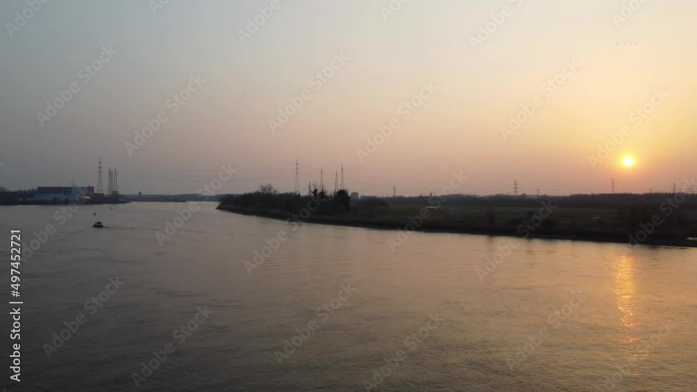 Silhouette of lonely boat in river Scheldt during sunset, aerial view Silhouette of lonely boat in river Scheldt during sunset, aerial view
