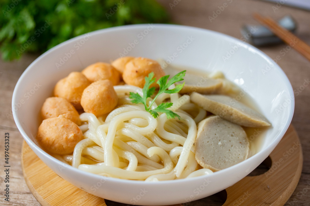 Udon, Shrimp Balls, and Fish Balls in Clear Soup Japanese Cuisine in a white porcelain cup