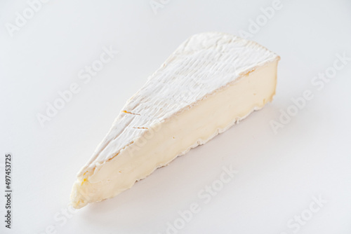 Cut pieces of whole and sliced camembert cheese
