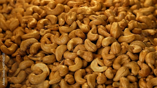 Lots of cashews sprinkled with salt background, cashew nut texture background.