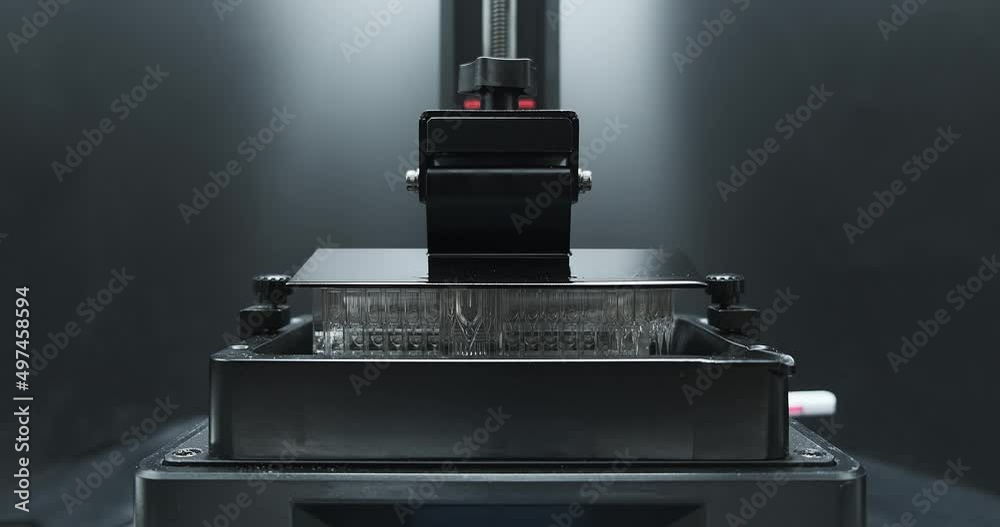 Front view of Resin MSLA3D Printer moving up and down during printing object.