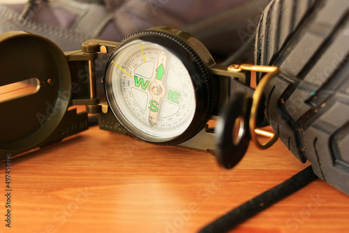 Tourist compass and old trekking boots