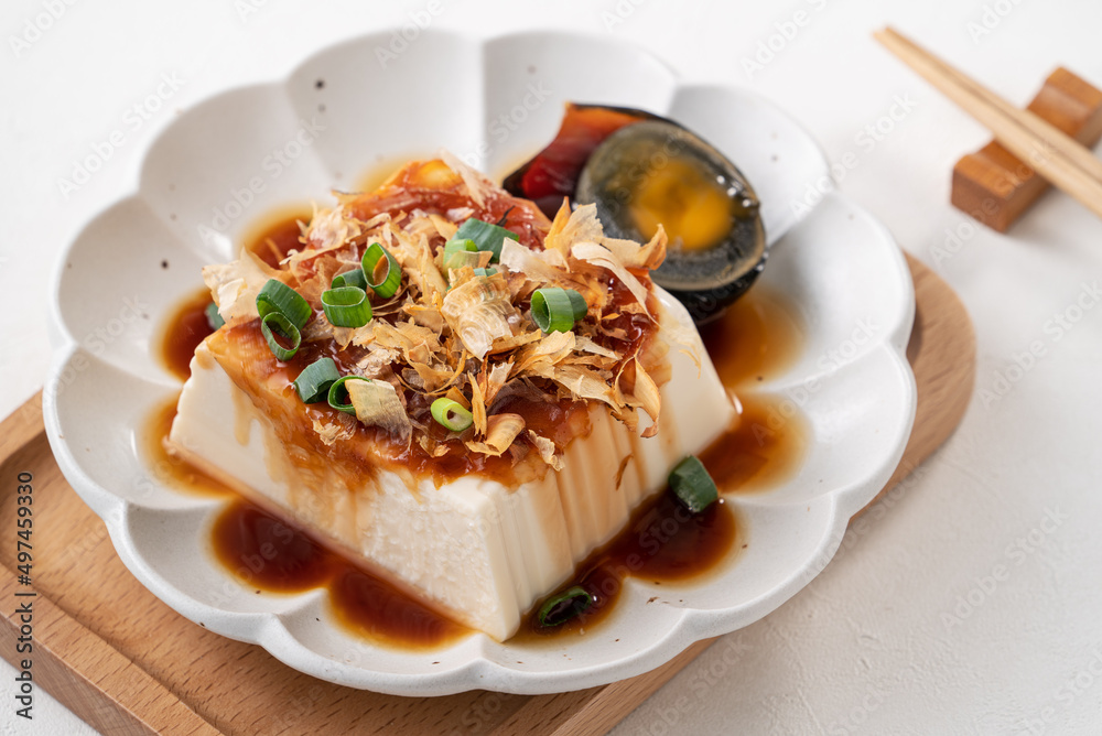 Delicious Chilled tofu and century egg with soy sauce and bonito flakes.