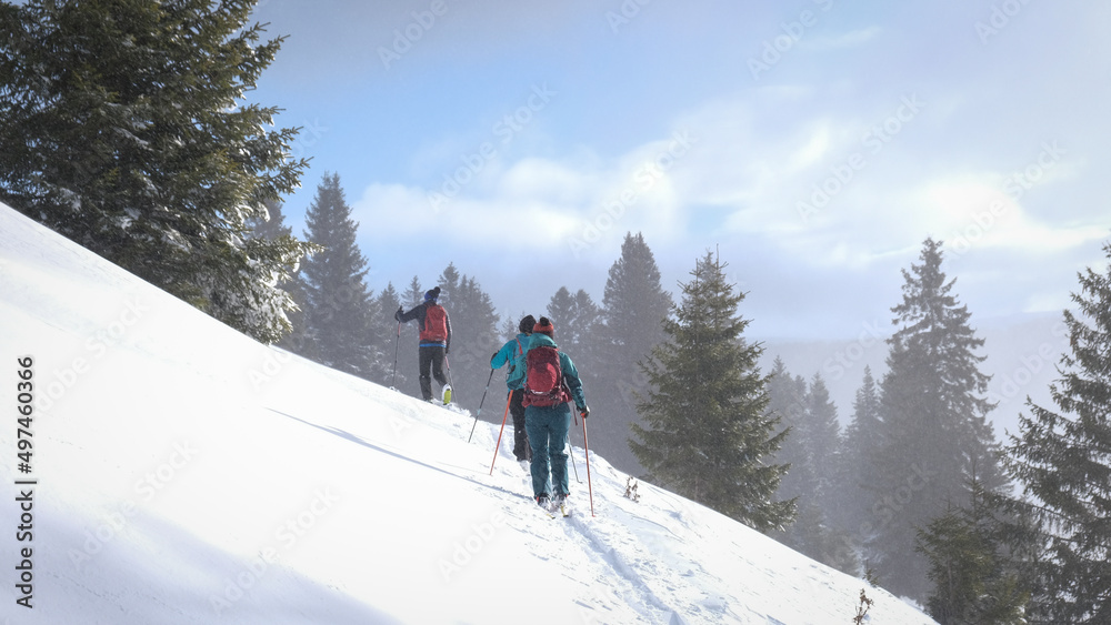 Ski touring skiers in Bucegi Mountains on a beautiful sunny day