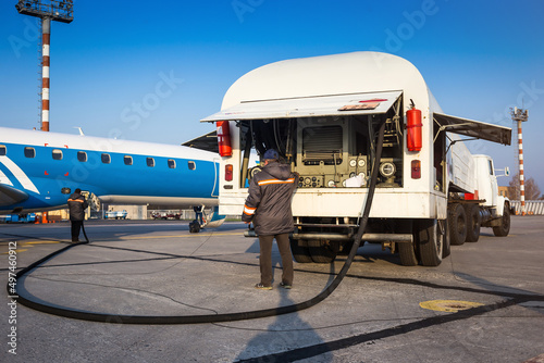 Aircraft refueling with a high pressure tanker. A passenger jet is being refueled from a supply truck. Airport Service photo