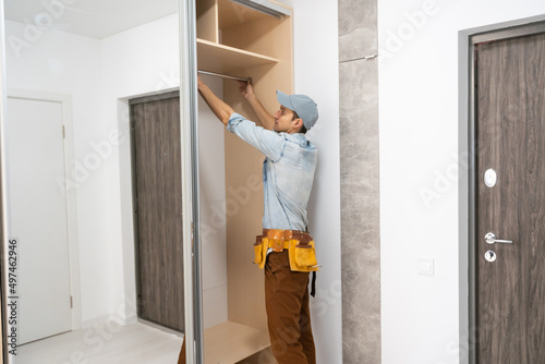 Wallpaper Mural repairman installs a sliding door wardrobe with a mirror Torontodigital.ca