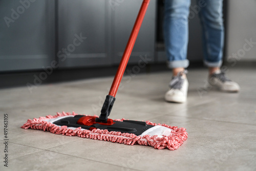 Close up of caucasian woman mopping the floor at home