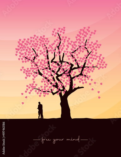 couple in love stands under a big tree at sunset