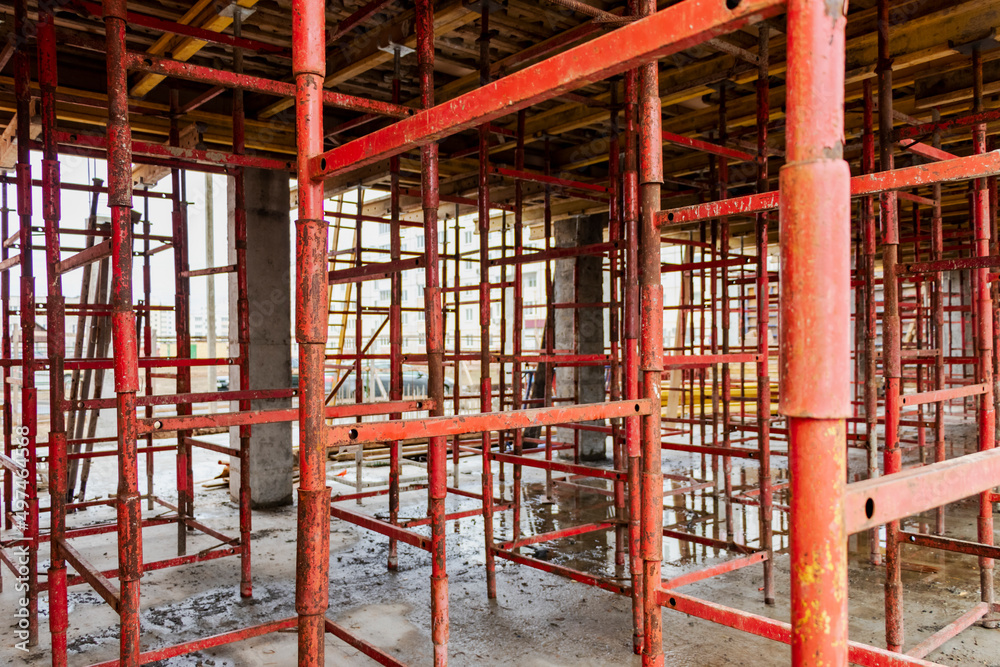 Reinforced concrete foundation of a modern monolithic residential building. Prepared formwork with reinforcing mesh for pouring concrete. Monolithic construction technologies. Reinforced concrete foundation of a modern monolithic residential building. Prepared formwork with reinforcing mesh for pouring concrete. Monolithic construction technologies.