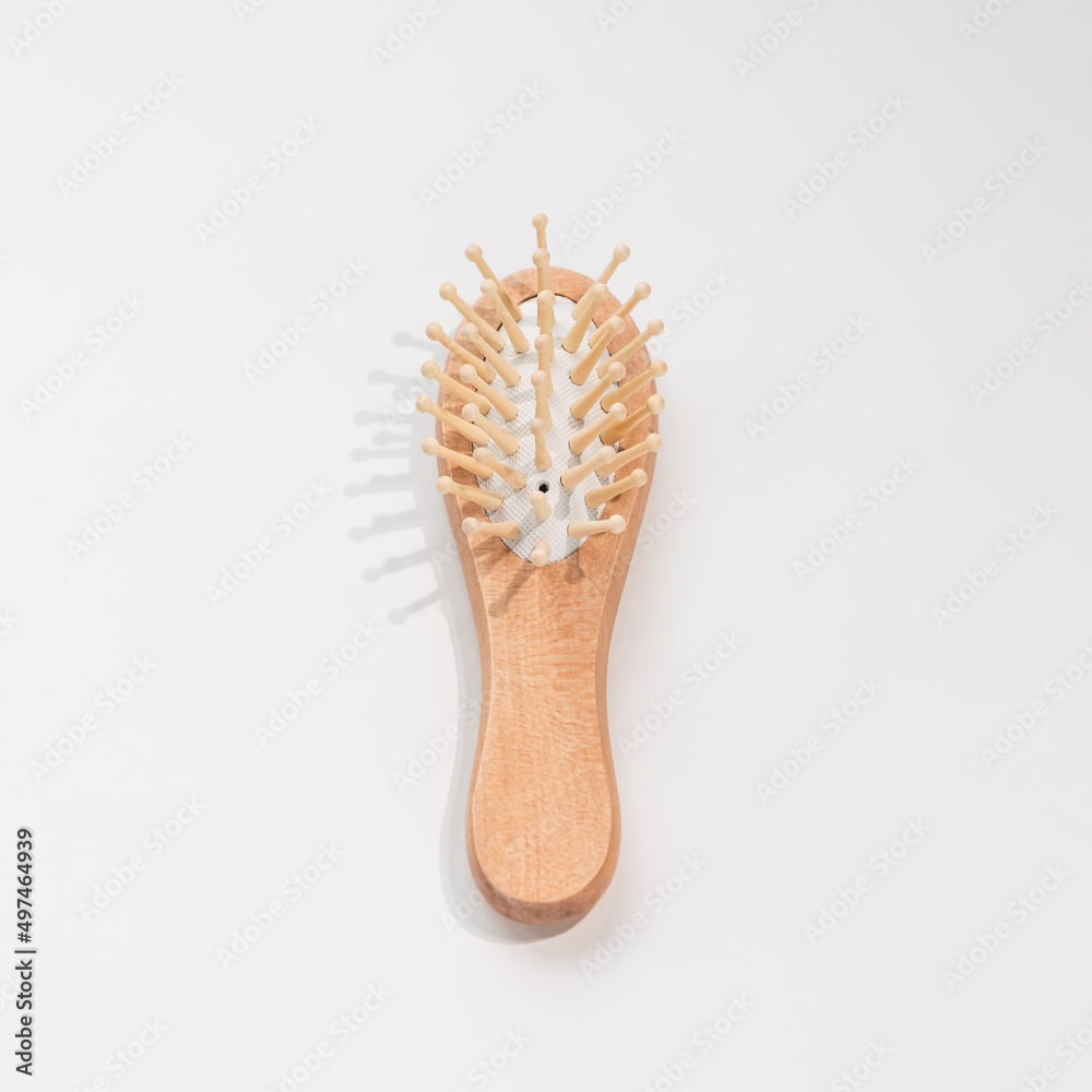 Wooden mini bamboo hair brush for travel, beard or kids on white background. Small pocket brush. Top view, copy space Wooden mini bamboo hair brush for travel, beard or kids on white background. Small pocket brush. Top view, copy space