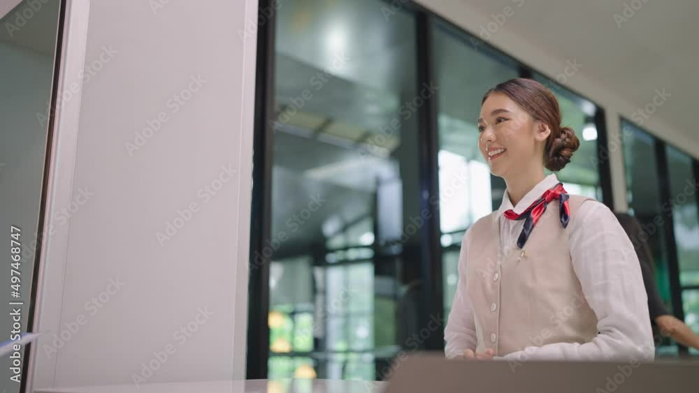 Passenger giving passport with boarding pass to air hostess Asian woman at check-in desk in airport Passenger giving passport with boarding pass to air hostess Asian woman at check-in desk in airport